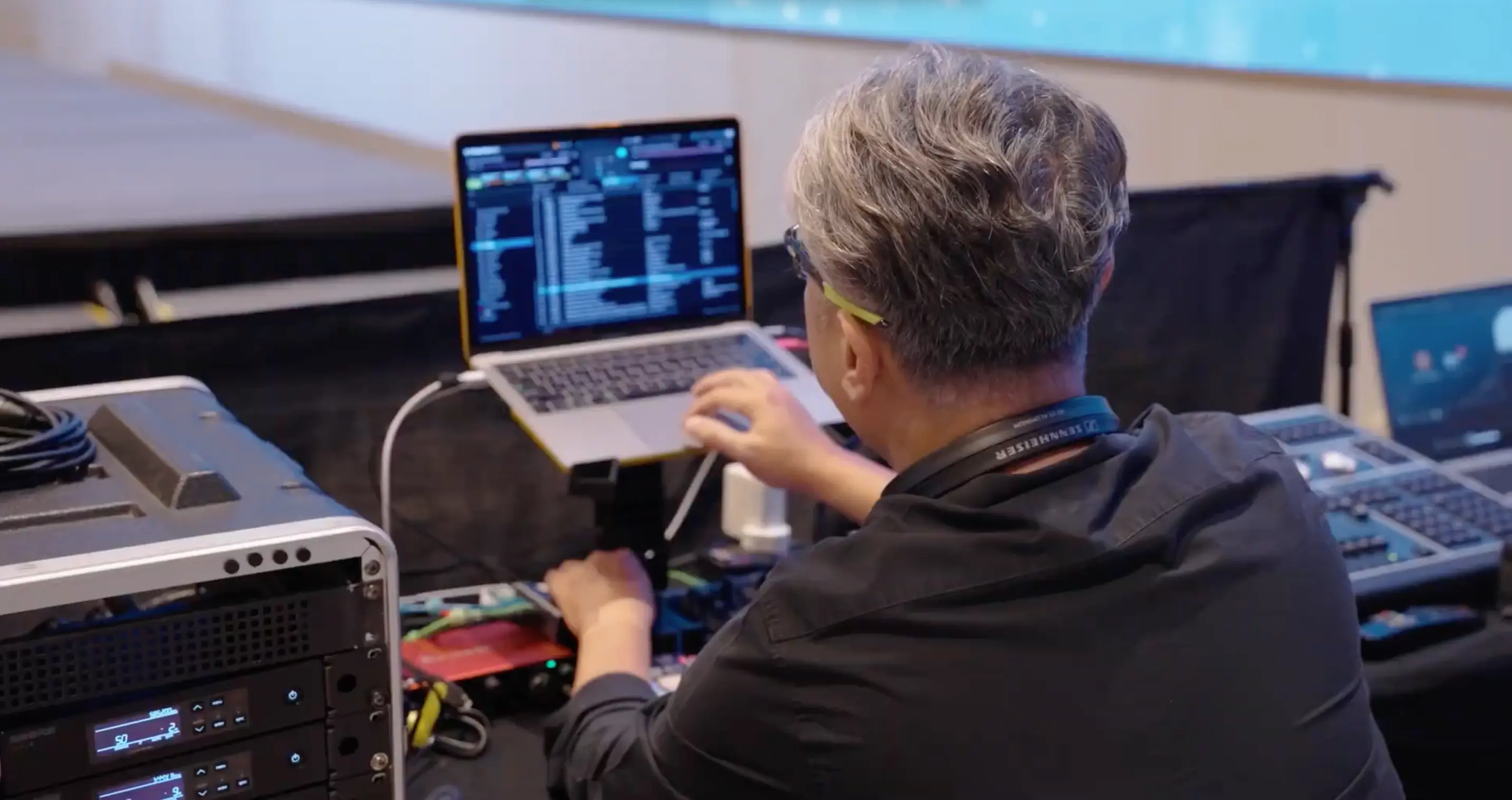 Technician operating audio, video and lighting control systems